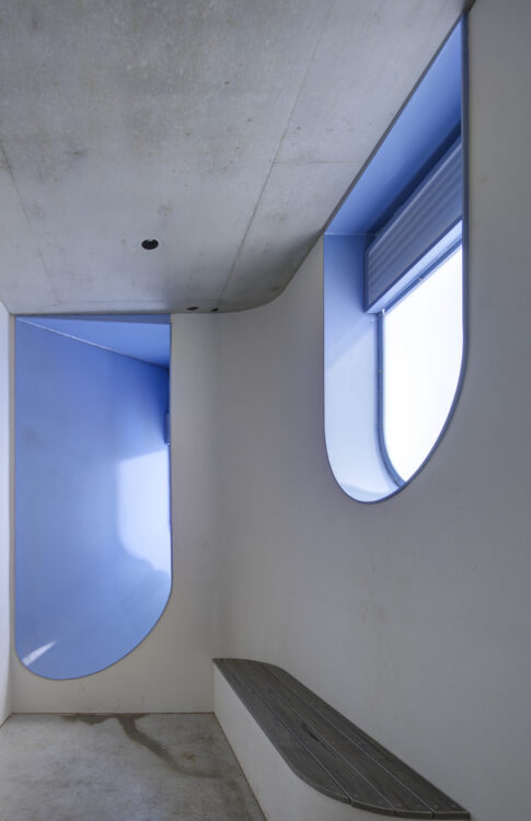 Curving windows inside public architecture bathroom cubicle